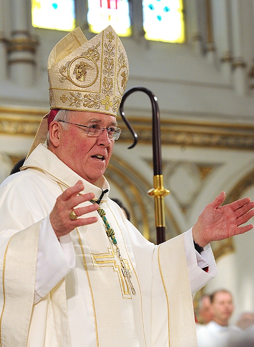 To the delight of the congregation Bishop Richard J. Malone announces the assignments of the new priests after a Mass at St. Joseph Cathedral where the four men were ordained into the priesthood. (Dan Cappellazzo/Staff Photographer)